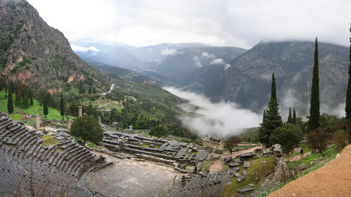 The ancient theatre of Delphi above a valley filled with cloud