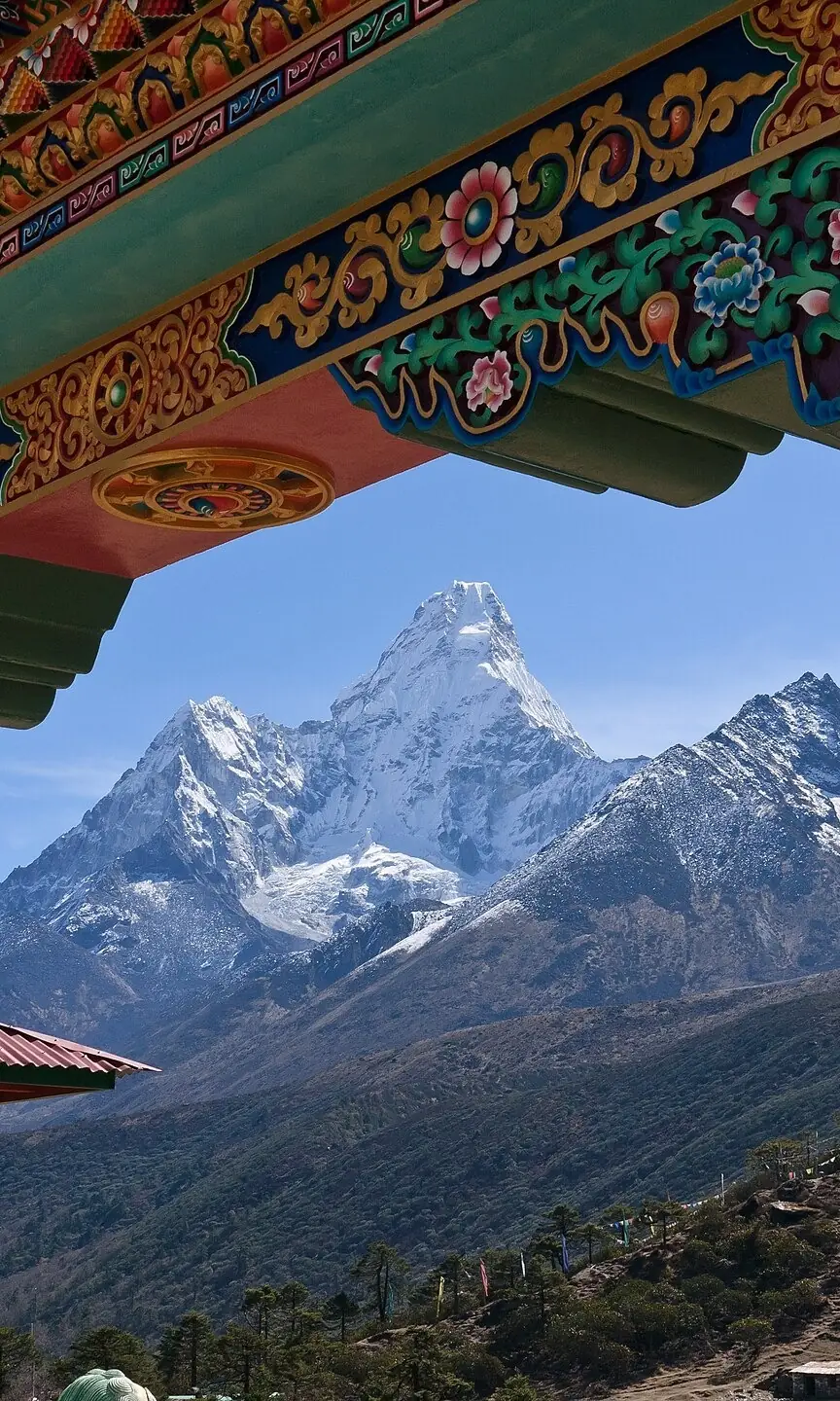 A painted Himalayan monastery gate framing the peak of Ama Dablam